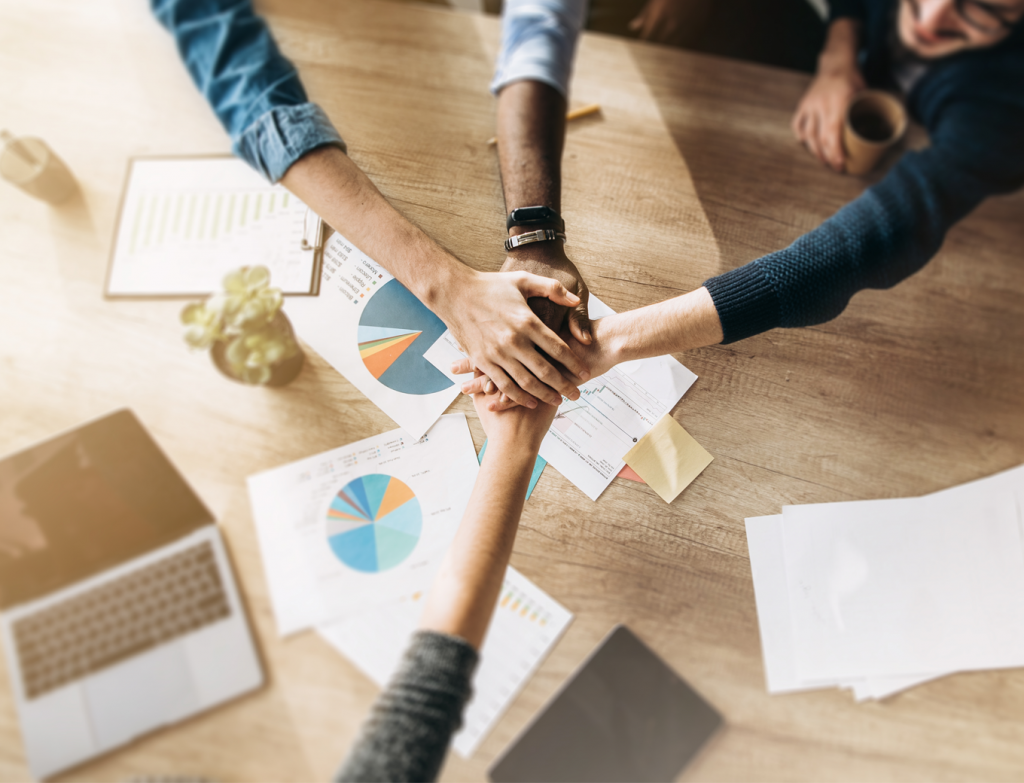 Entrepreneurs hands over table for teamwork